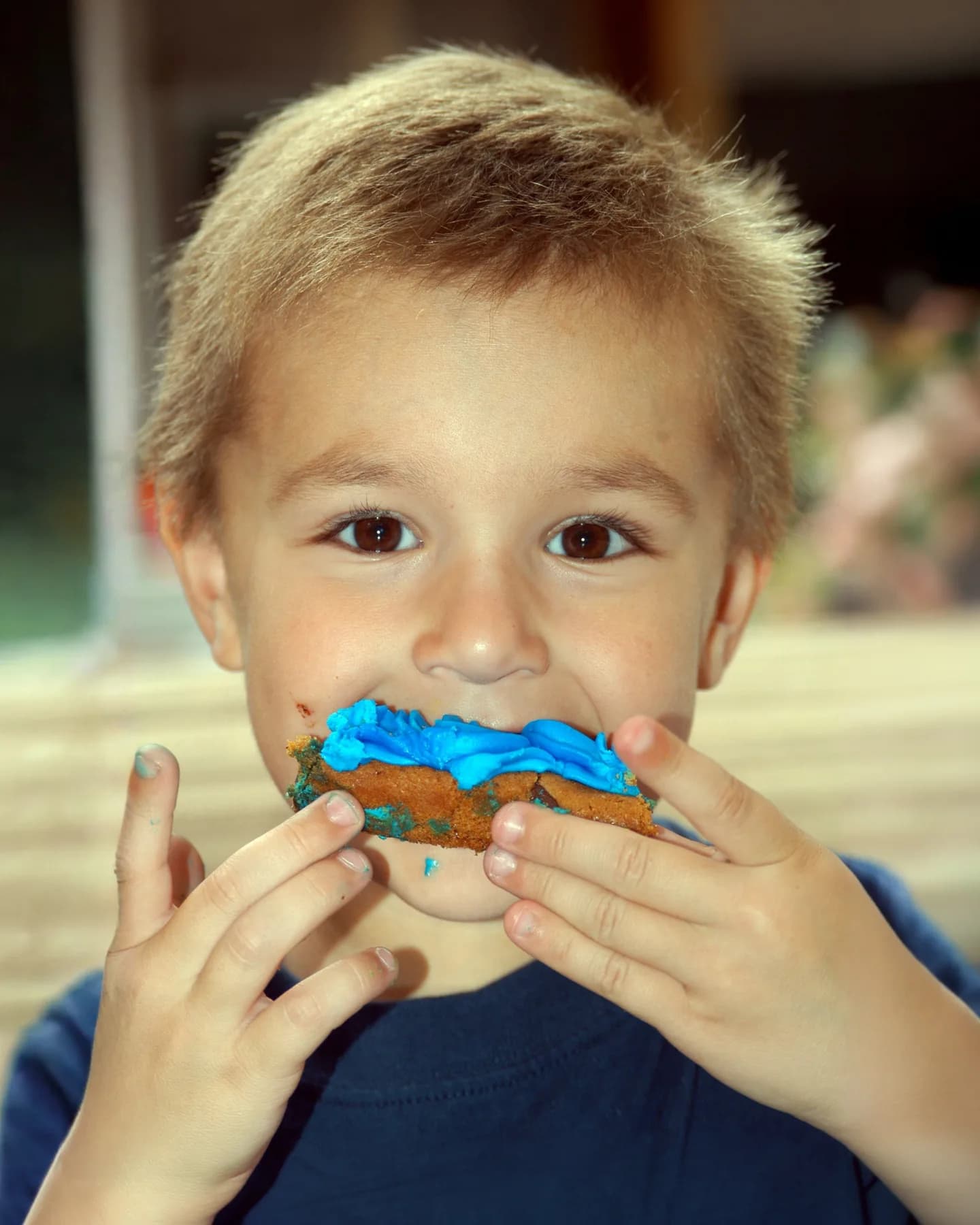 A childhood close-up with bright blue frosting