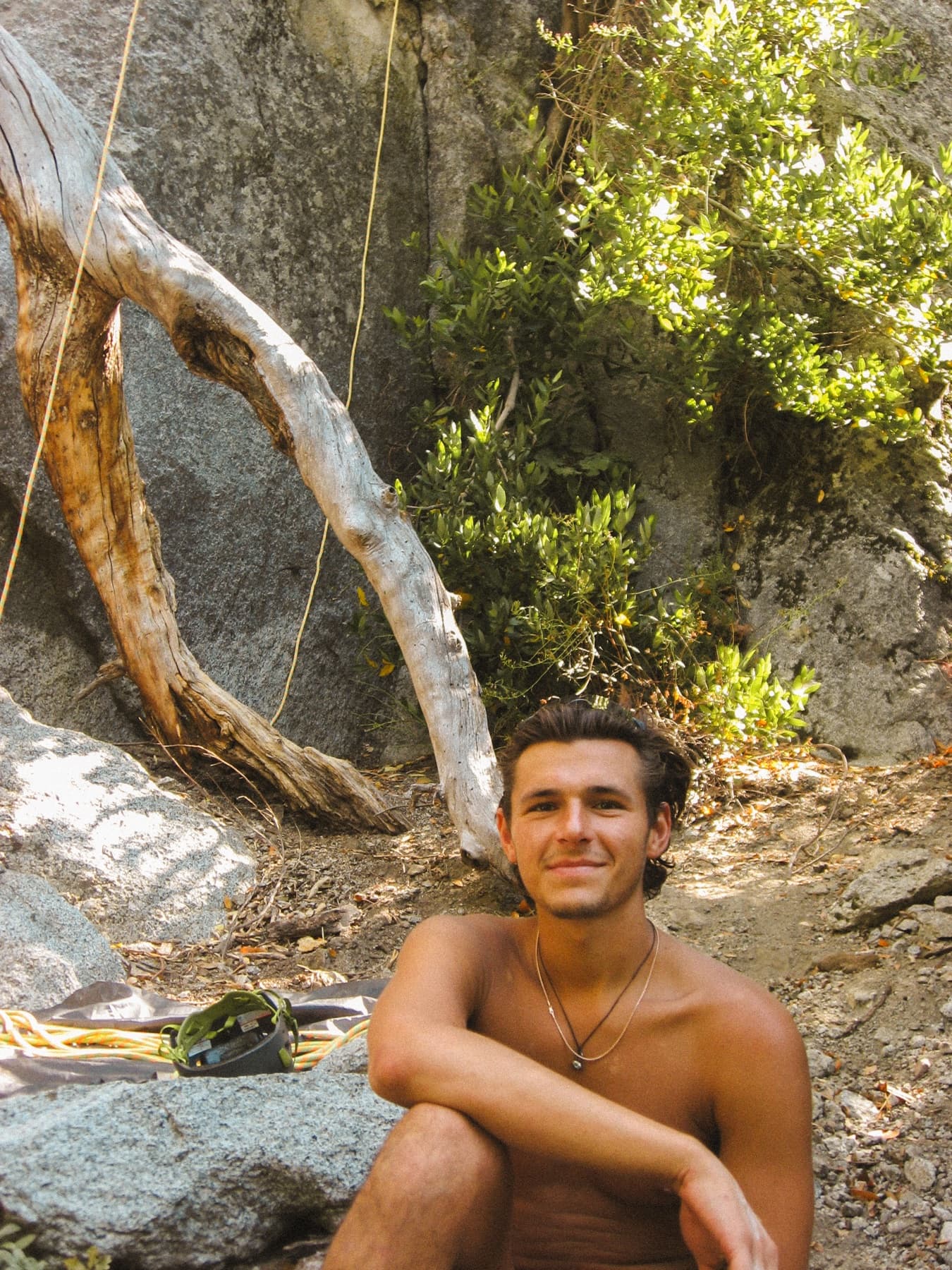 Jake resting beside climbing gear outdoors